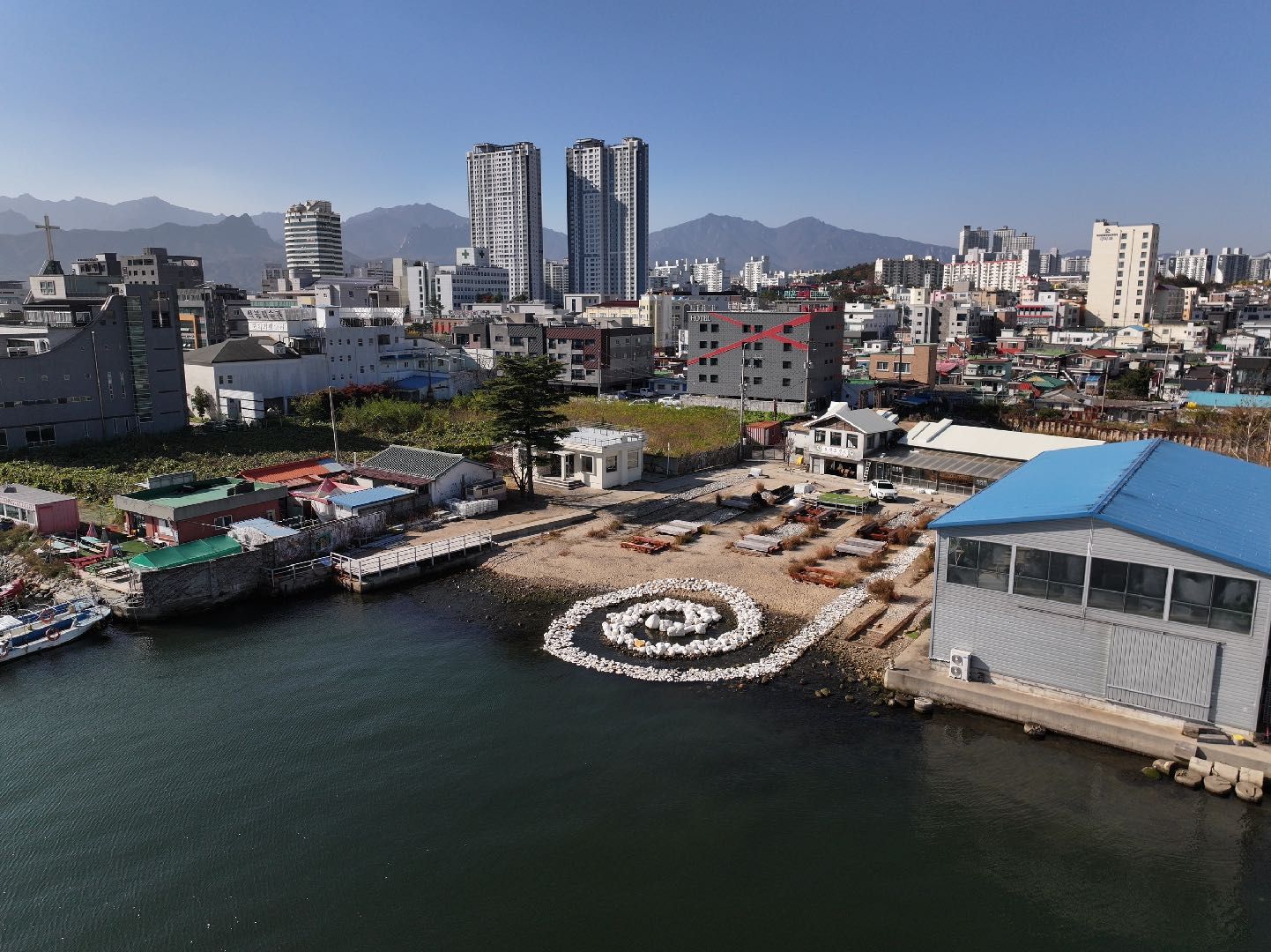 The New Rock spiral seen from above with the harbour and city of Sokcho behind
